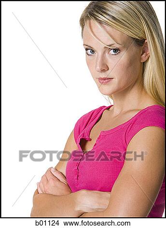 Portrait of a young woman with her arms crossed View Large Photo Image Picture - Portrait of a young woman with her arms crossed. Fotosearch