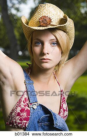 Portrait of a young woman with her arms raised View Large Photo Image Picture - Portrait of a young woman with her arms raised. Fotosearch
