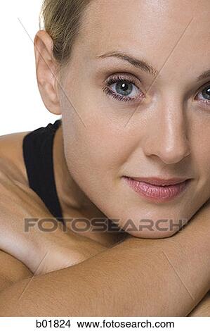 Portrait of a young woman with her arms folded View Large Photo Image Picture - Portrait of a young woman with her arms folded. Fotosearch