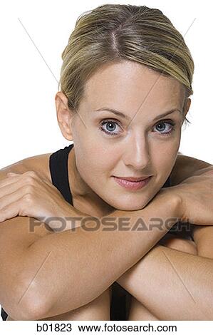 Stock Image - Portrait of a young woman with her arms folded. Fotosearch