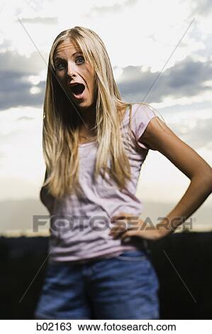 Portrait of a young woman with her mouth open View Large Photo Image Stock Image - Portrait of a young woman with her mouth open. Fotosearch