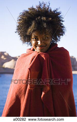 Portrait of a young woman wrapped in a blanket View Large Photo Image Stock Image - Portrait of a young woman wrapped in a blanket. Fotosearch