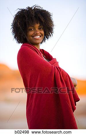 Stock Photo - Portrait of a young woman wrapped in a towel. Fotosearch