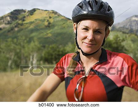 Portrait of an adult woman wearing a cycling helmet View Large Photo Image Stock Image - Portrait of an adult woman wearing a cycling helmet. Fotosearch