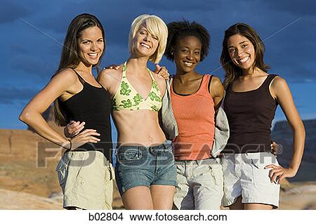 Portrait of four young women smiling View Large Photo Image Picture - Portrait of four young women smiling. Fotosearch
