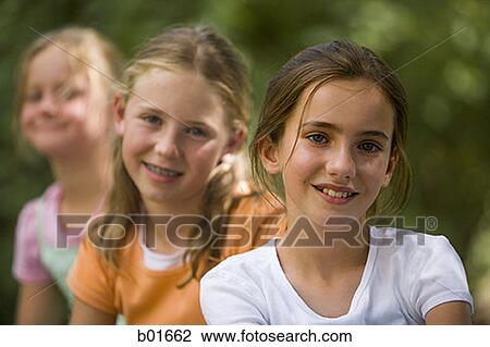 Portrait of three girls sitting View Large Photo Image Stock Image - Portrait of three girls sitting. Fotosearch