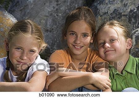 Portrait of three girls sitting together View Large Photo Image Stock Image - Portrait of three girls sitting together. Fotosearch