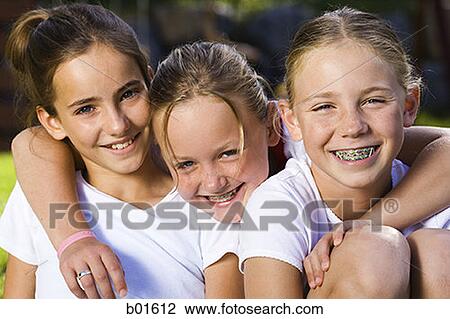 Portrait of three girls smiling View Large Photo Image Stock Image - Portrait of three girls smiling. Fotosearch