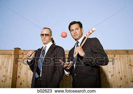 Portrait of two businessmen carrying a croquet mallet View Large Photo Image Stock Image - Portrait of two businessmen carrying a croquet mallet. Fotosearch