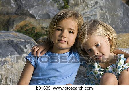 Portrait of two girls sitting View Large Photo Image Stock Photo - Portrait of two girls sitting. Fotosearch