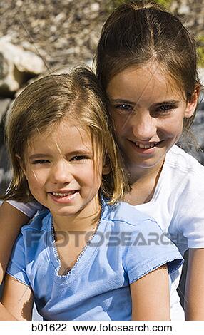 Stock Image - Portrait of two girls smiling. Fotosearch