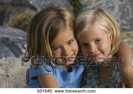 Stock Image - Portrait of two girls smiling. Fotosearch