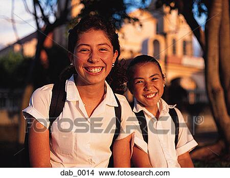 Portrait of two school girls smiling View Large Photo Image Picture - Portrait of two school girls smiling. Fotosearch