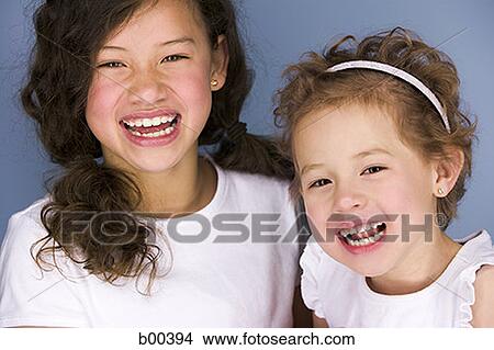 Portrait of two sisters laughing View Large Photo Image Picture - Portrait of two sisters laughing. Fotosearch