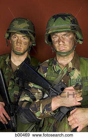Portrait of two soldiers holding their rifles View Large Photo Image Stock Photo - Portrait of two soldiers holding their rifles. Fotosearch