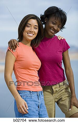 Portrait of two young women smiling View Large Photo Image Picture - Portrait of two young women smiling. Fotosearch