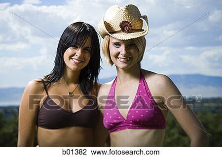 Stock Image - Portrait of two young women smiling. Fotosearch