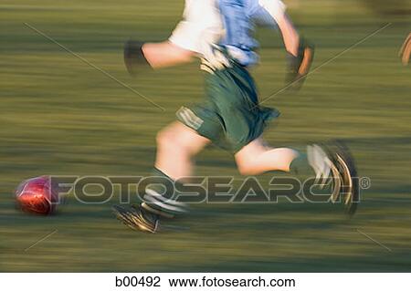 Profile of a boy playing soccer View Large Photo Image Stock Image - Profile of a boy playing soccer. Fotosearch