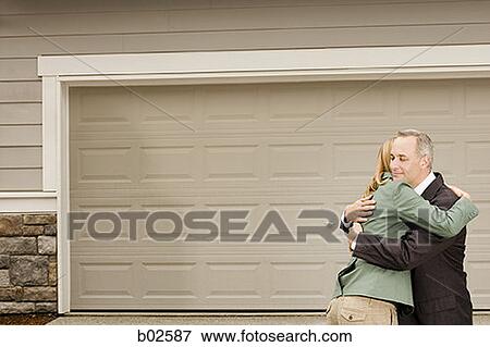 Stock Photo - Profile of a businessman embracing a businesswoman. Fotosearch