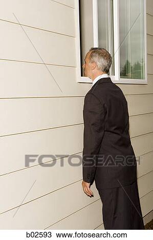 Profile of a businessman peeping through a window View Large Photo Image Stock Image - Profile of a businessman peeping through a window. Fotosearch