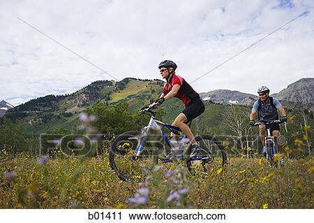 Profile of a couple mountain biking View Large Photo Image Stock Image - Profile of a couple mountain biking. Fotosearch