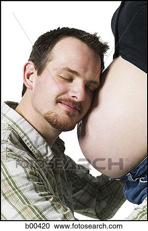 Profile of a man resting his head on his pregnant wife's abdomen View Large Photo Image Stock Image - Profile of a man resting his head on his pregnant wife's abdomen. Fotosearch