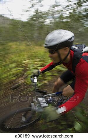 Profile of a mature man mountain biking View Large Photo Image Stock Photo - Profile of a mature man mountain biking. Fotosearch