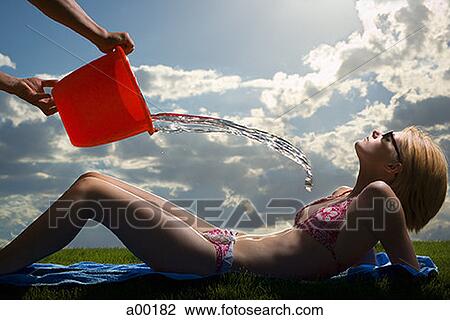 Profile of a person throwing water on a young woman View Large Photo Image Stock Image - Profile of a person throwing water on a young woman. Fotosearch