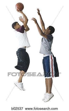 Profile of a teenage boy and a young man playing basketball View Large Photo Image Stock Photo - Profile of a teenage boy and a young man playing basketball. Fotosearch