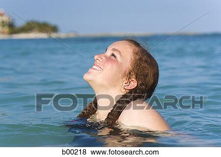 Profile of a teenage girl smiling in the ocean View Large Photo Image Stock Photo - Profile of a teenage girl smiling in the ocean. Fotosearch