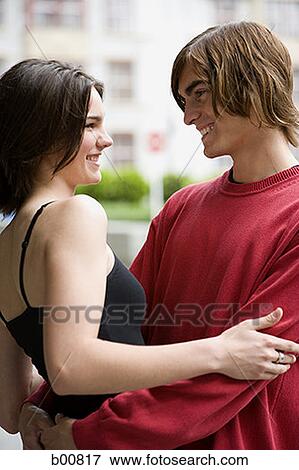Profile of a young couple embracing View Large Photo Image Stock Photo - Profile of a young couple embracing. Fotosearch