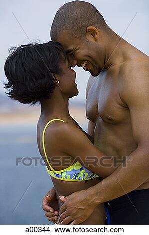 Profile of a young couple hugging each other View Large Photo Image Picture - Profile of a young couple hugging each other. Fotosearch