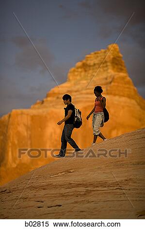 Profile of a young couple walking View Large Photo Image Stock Photography - Profile of a young couple walking. Fotosearch