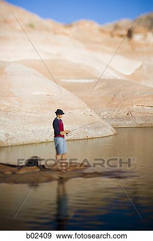 Profile of a young man fishing View Large Photo Image Stock Photo - Profile of a young man fishing. Fotosearch