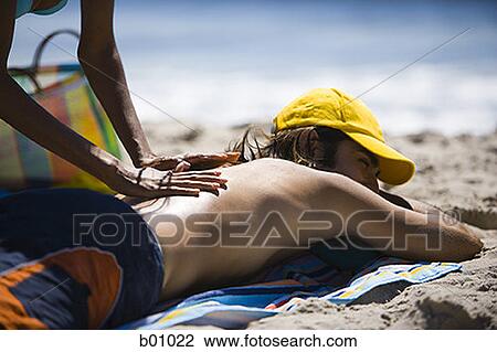 Profile of a young woman giving a young man a massage View Large Photo Image Stock Image - Profile of a young woman giving a young man a massage. Fotosearch