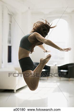 Profile of a young woman jumping View Large Photo Image Stock Image - Profile of a young woman jumping. Fotosearch