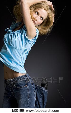 Profile of a young woman jumping View Large Photo Image Stock Photo - Profile of a young woman jumping. Fotosearch
