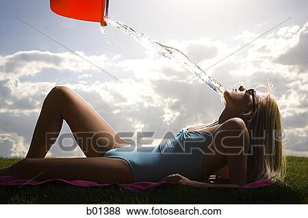 Profile of a young woman lying in a lawn View Large Photo Image Stock Photo - Profile of a young woman lying in a lawn. Fotosearch