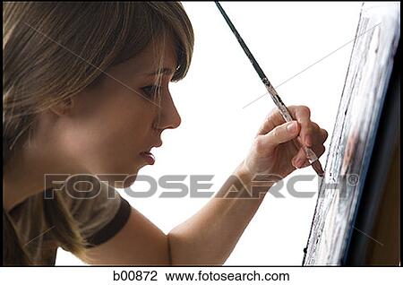 Profile of a young woman painting on a canvas View Large Photo Image Stock Image - Profile of a young woman painting on a canvas. Fotosearch