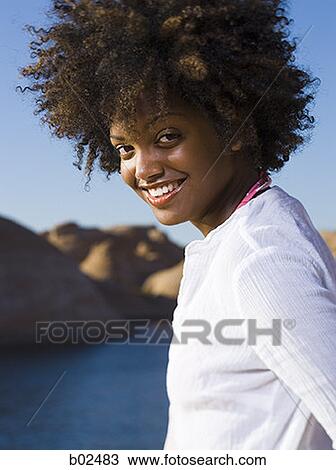 Stock Image - Profile of a young woman smiling. Fotosearch