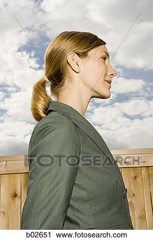 Profile of a young woman standing View Large Photo Image Stock Image - Profile of a young woman standing. Fotosearch