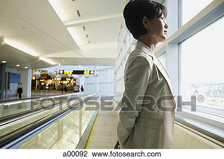 Profile of an Asian businesswoman standing at an airport View Large Photo Image Stock Image - Profile of an Asian businesswoman standing at an airport. Fotosearch