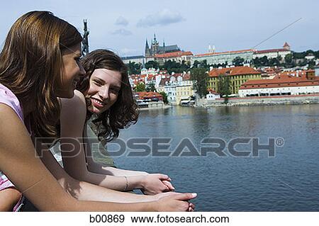 Profile of two teenage girls standing at a lakeside View Large Photo Image Stock Photo - Profile of two teenage girls standing at a lakeside. Fotosearch
