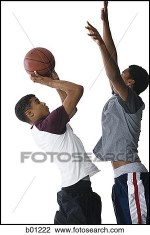 Profile of two young men playing basketball View Large Photo Image Stock Image - Profile of two young men playing basketball. Fotosearch