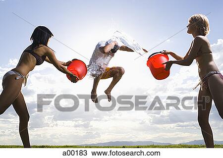Profile of two young women throwing water on a man View Large Photo Image Stock Image - Profile of two young women throwing water on a man. Fotosearch