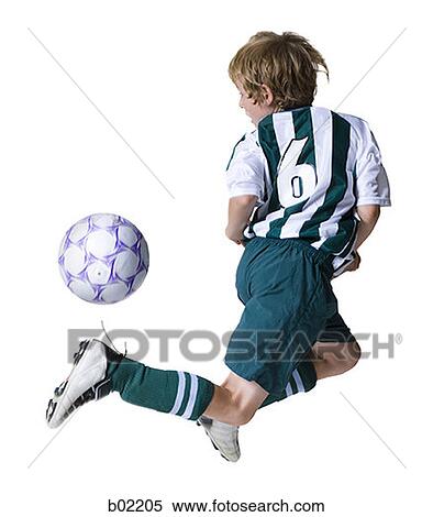 Rear view of a boy playing a soccer ball View Large Photo Image Stock Photography - Rear view of a boy playing a soccer ball. Fotosearch