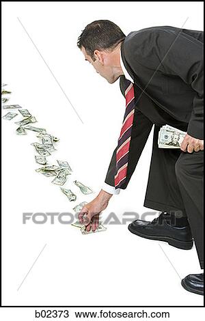 Rear view of a businessman picking up fallen money View Large Photo Image Stock Image - Rear view of a businessman picking up fallen money. Fotosearch
