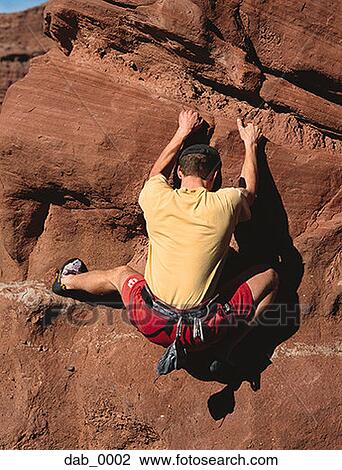 Rear view of a man rock climbing View Large Photo Image Stock Image - Rear view of a man rock climbing . Fotosearch