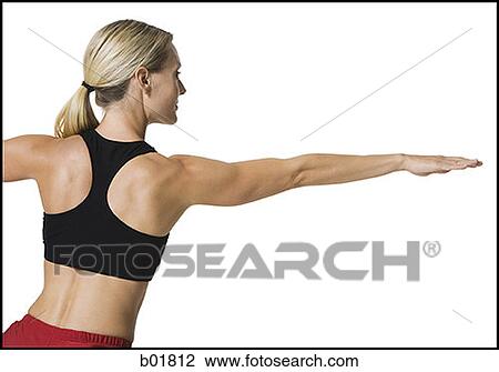 Stock Image - Rear view of a young woman stretching. Fotosearch