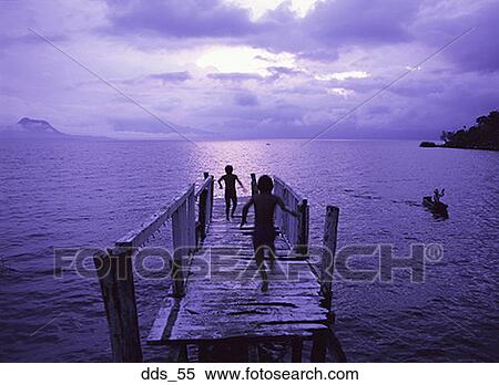 Rear view of two children running on a wooden pier View Large Photo Image Stock Photography - Rear view of two children running on a wooden pier. Fotosearch